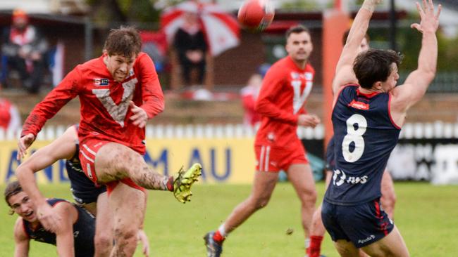 North Ãdelaide’s Aaron Young gets his kick away under pressure against the Redlegs at Prospect. Picture: Brenton Edwards.