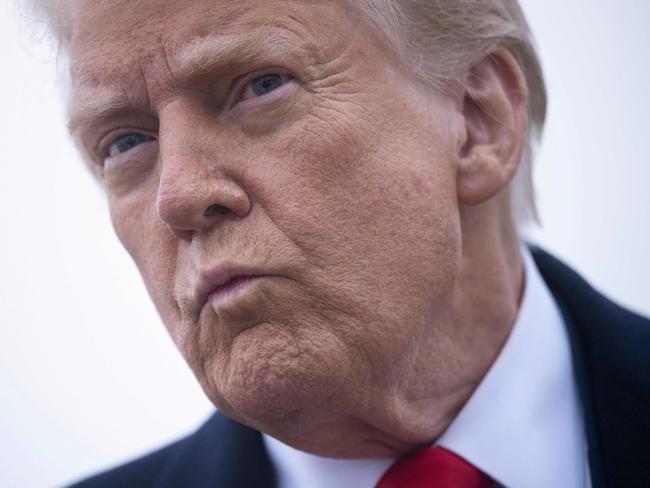 TOPSHOT - US President Donald Trump speaks to the press about the conflict in Ukraine before boarding Air Force One at Andrews Air Force Base March 14, 2025, in Maryland. Trump is spending the weekend at his Florida Mar-a-Lago resort. (Photo by Brendan Smialowski / AFP)