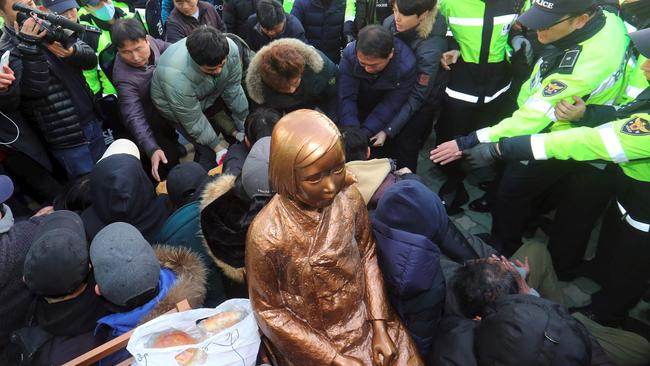 South Korean activists staged a sit-in protest to prevent government employees from seizing the statue. Picture: AFP