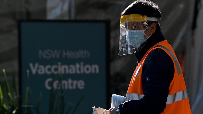 NSW Health workers wore Personal Protection Equipment (PPE) to hand out masks and hand sanitiser at the NSW Health Covid-19 Vaccination Hub at Sydney Olympic Park. Picture: NCA NewsWire/Bianca De Marchi