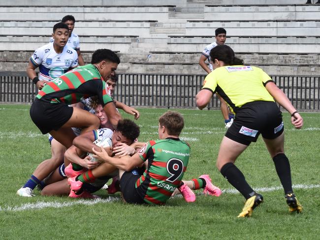 Lennox Tuiloma tries to ground the ball with Cody Hill desperately trying to hold him up. Picture: Sean Teuma