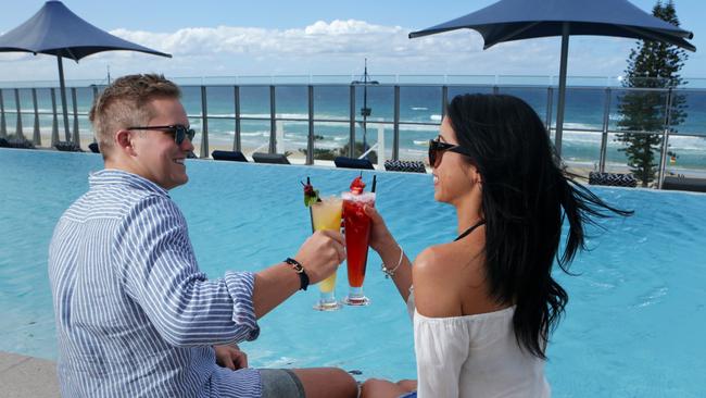 Clare Rigby, 21, and Luke Roberts 20, on the pool deck at Soul Mantra Surfers Paradise. Pic Tim Marsden