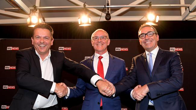 SA Best leader Nick Xenophon, Premier Jay Weatherill and Liberal leader Steven Marshall shake hands at the Sky News people's forum in Elizabeth on Wednesday night. Picture: Tracey Nearmy/AAP