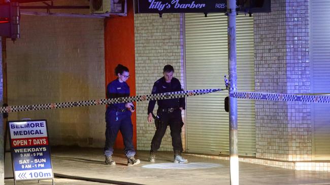 Police officers comb the crime scene. Picture: Bill Hearne