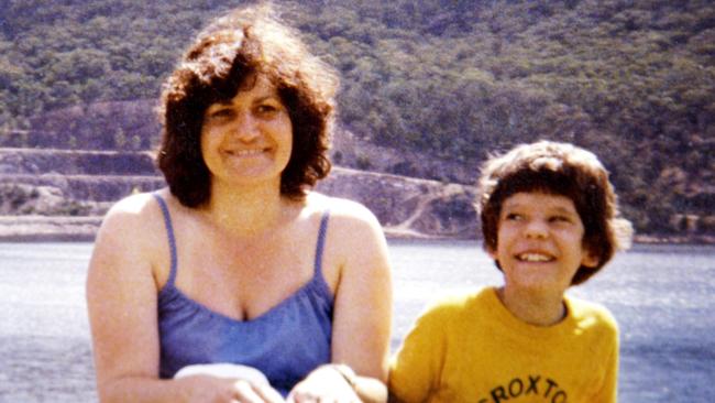 Maria James, pictured with her son Adam the year she was killed, was devoted to her two sons. She ran a bookshop in front of her home.