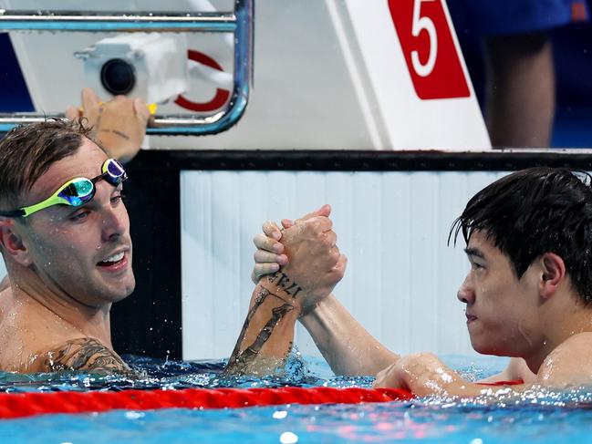 NANTERRE, FRANCE - JULY 31: Zhanle Pan of Team People's Republic of China celebrates with Kyle Chalmers of Team Australia after winning gold and silver in the Men's 100m Freestyle Final on day five of the Olympic Games Paris 2024 at Paris La Defense Arena on July 31, 2024 in Nanterre, France. (Photo by Quinn Rooney/Getty Images)