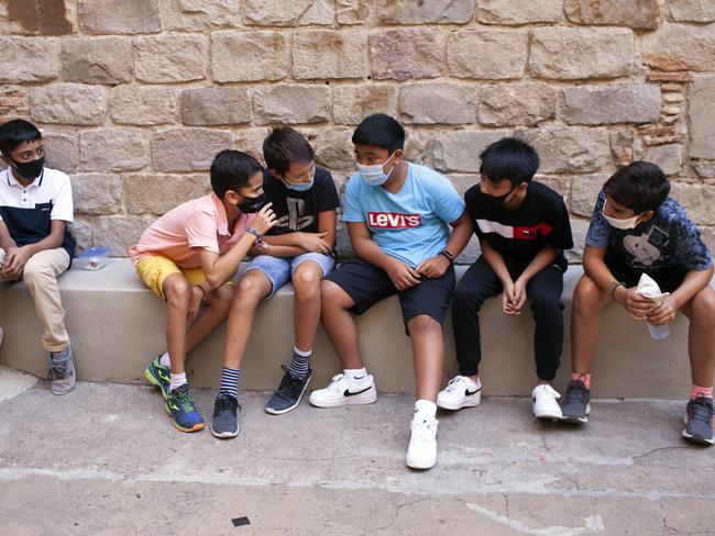 Students sit outside school in Barcelona. Picture: Getty Images