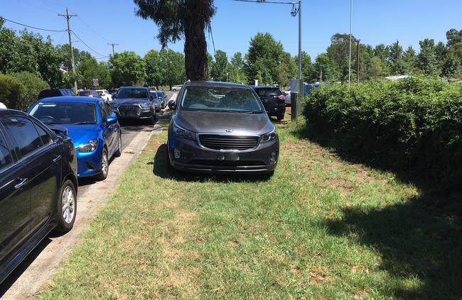 Cars have mounted kerbs for a parking spot on the most popular days at Curry Reserve Water Play Park.