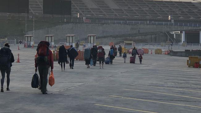 Stranded travellers wander outside Kathmandu’s international airport early on March 24 2020. Picture: Anthony Keane