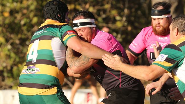 Surfers lock Tyler Meredith tackles Colleges’ Kerrod Martorella. Picture: Mike Batterham