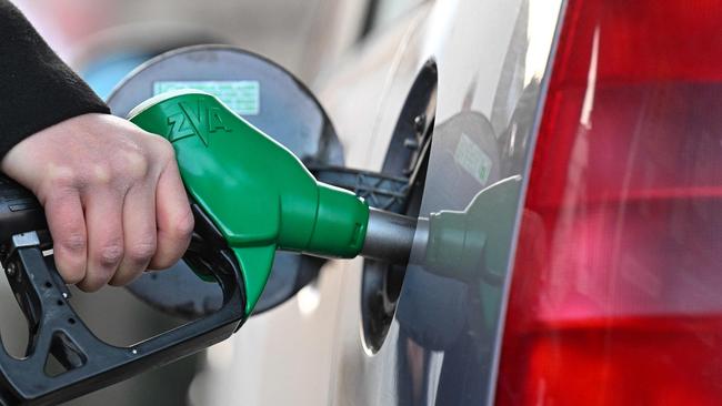 (FILES) In this file photo taken on March 08, 2022 A woman fills up her car with diesel at a petrol station in Mulhouse, eastern France, on March 8, 2022. - The French government has announced a package worth 2.0 billion euros ($2.2 billion) to help consumers struggling with soaring fuel prices, with the cost of filling up set to be cut at the pump. (Photo by SEBASTIEN BOZON / AFP)