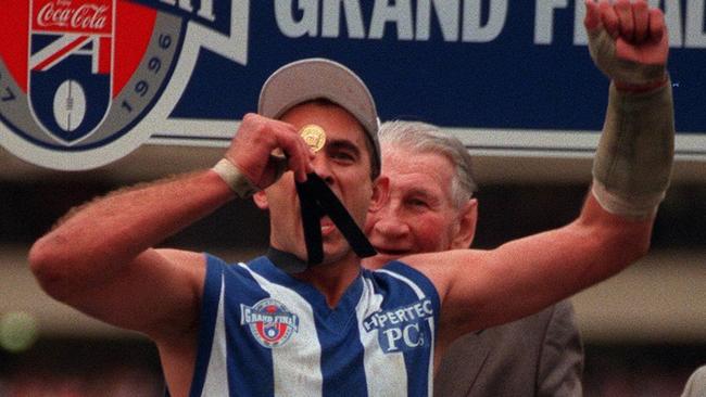 Wayne Schwass with his 1996 premiership medal where he said he had dark thoughts despite it being a happy day.