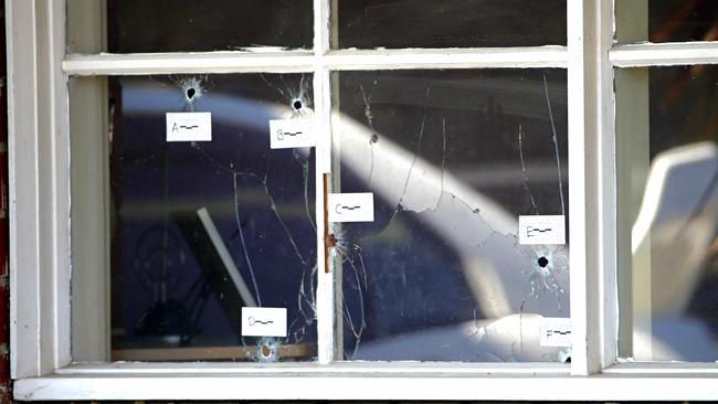 Bullet holes marked by forensic police show where they entered Mr Adra’s house. Picture: Ian Currie