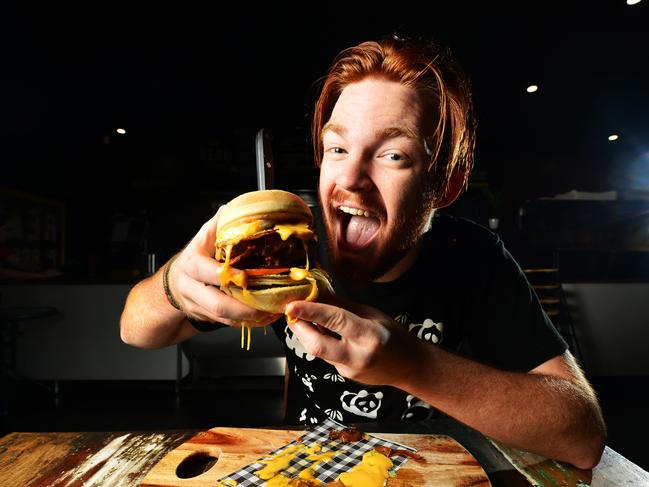 Jack McLeod eats the new 'Bogan Burger' from Real Burger Co. Picture: Zak Simmonds