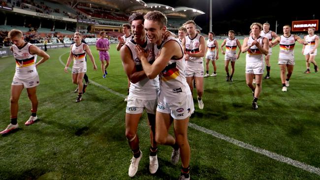 Shane McAdam and Lachlan Sholl celebrate the Crows’ win at Adelaide Oval