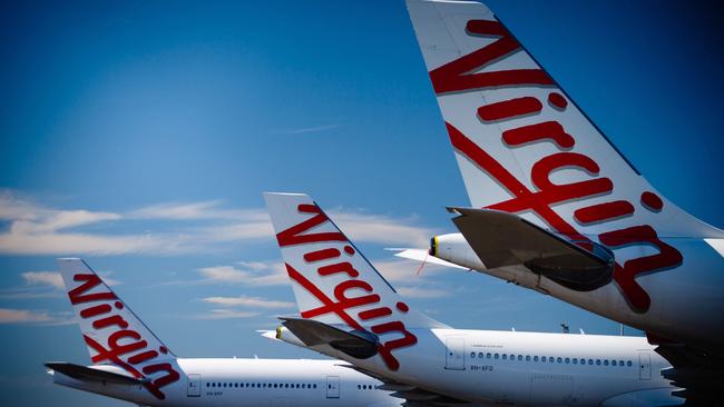 Virgin Australia aircraft parked at Brisbane Airport. The airline could soon emerge from administration under new owners Bain Capital. Picture: Patrick Hamilton/AFP