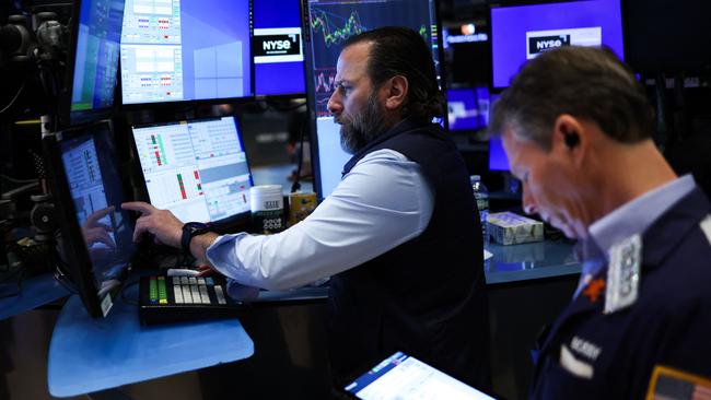 Traders and financial professionals work on the floor of the New York Stock Exchange at the opening bell in New York. Picture: Charly Triballeau/AFP