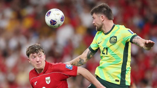 Socceroos defender Cameron Burgess (right) wins a header during Australia’s 5-1 victory over Indonesia in Sydney. Picture: Mark Metcalfe/Getty Images