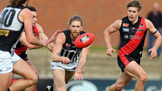 Port Adelaide’s Aaron Young fires out a handpass. Picture: TOM HUNTLEY