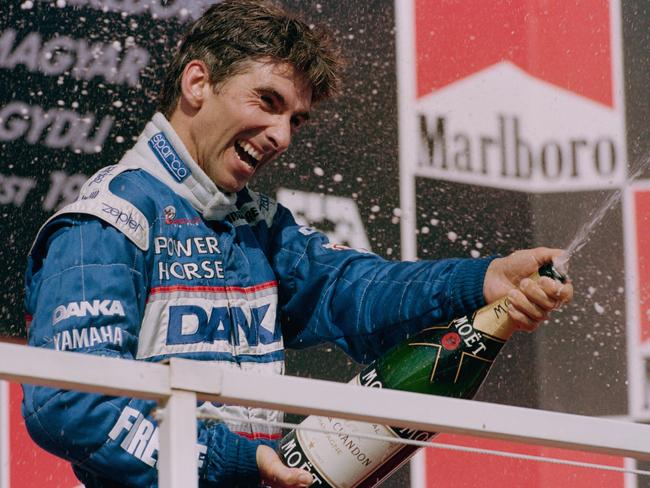 Damon Hill of Great Britain and driver of the #1 Danka Arrows Yamaha Arrows A18 Yamaha 0X11A V10 sprays champagne to celebrate his second place at the Hungarian Grand Prix on 10th August 1997 at the Hungaroring Circuit, Budapest, Hungary. (Photo by Michael Coopern/Getty Images)