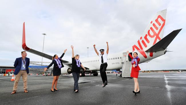 Virgin Australia flight crew celebrating their return to work after Queensland borders reopened to Sydney and Victoria. Picture: Scott Powick