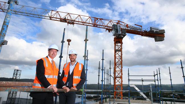 St Hilliers celebrates the “topping out” of the NSW Department of Finance, Services and Innovation development with Property NSW Executive Leon Walker and St Hilliers group general manager Dan Hinton braving the rooftop. Pictures: Sue Graham