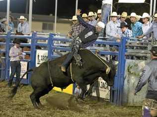 Josh Jones on his way to qualifying for the final in the open bullride at the Lawrence Twilight Rodeo. Picture: Adam Hourigan