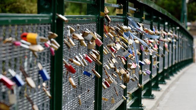 Hundreds of padlocks adorn the Adelaide uni footbridge. The practice is under a cloud, with Adelaide City Council considering their future. Picture: Roy VanDerVegt