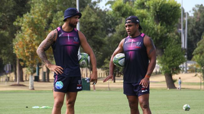 Quade Cooper (left) and Will Genia talk tactics at training. Picture: Rebels