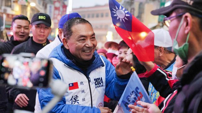 Hou Yu-ih, presidential candidate from the main opposition Kuomintang (KMT), shakes hands with supporters in New Taipei City. Picture: AFP