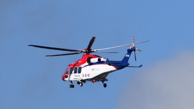 The Queensland Government Air (GQAir) rescue helicopter transports a critically injured person Townsville University Hospital. Picture: Cameron Bates