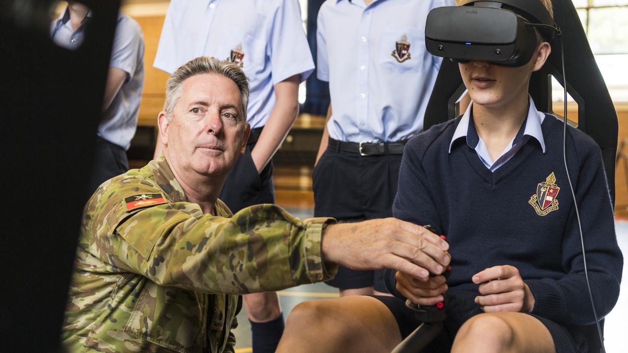 Aviation STEM Motivation Program OIC Major David McEvoy instructs Toowoomba Anglican School student Lachlan Weier in the use of a VR helicopter flight simulator. Picture: Kevin Farmer