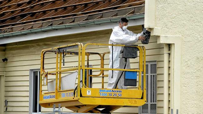 Workers remove the roof from the old firemans hall in Limestone Street in preparation for its demolition to extend the McDonald's carpark. Picture: Rob Williams