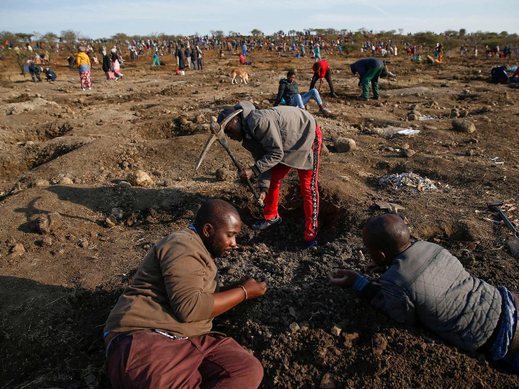 Fortune hunters dig for what they believe to be diamonds after the discovery of unidentified stones at KwaHlathi village near Ladysmith, South Africa, on June 15. Picture: Phill Magakoe/AFP