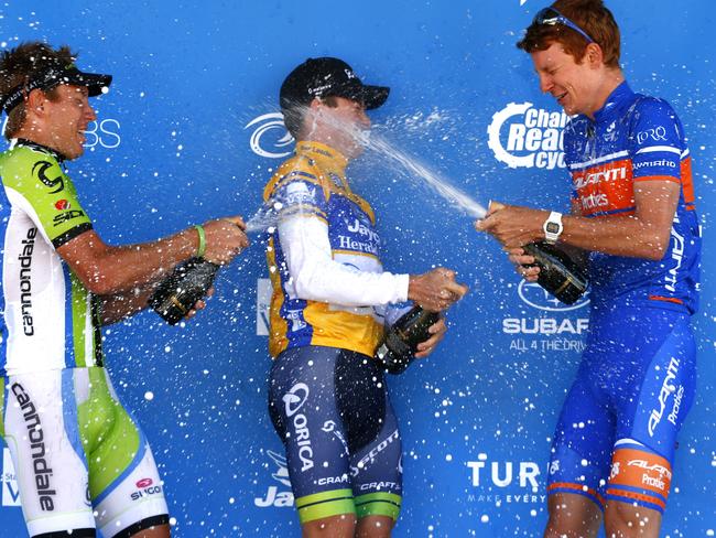 Herald Sun Tour winner Simon Clarke of the Orica GreenEdge team gets a champagne shower from Cameron Wurf (left) and Jack Haig (right) on the podium. Picture: Michael Klein.