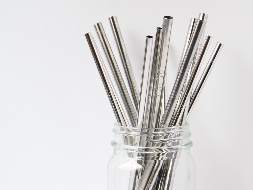 Replacing plastic drinking straws with metal straw concept. Woman