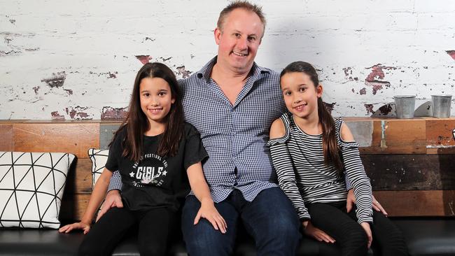 Nova radio’s Jay Walkerden with 10-year-old twin daughters Holly and Amelia. Picture: Josh Woning