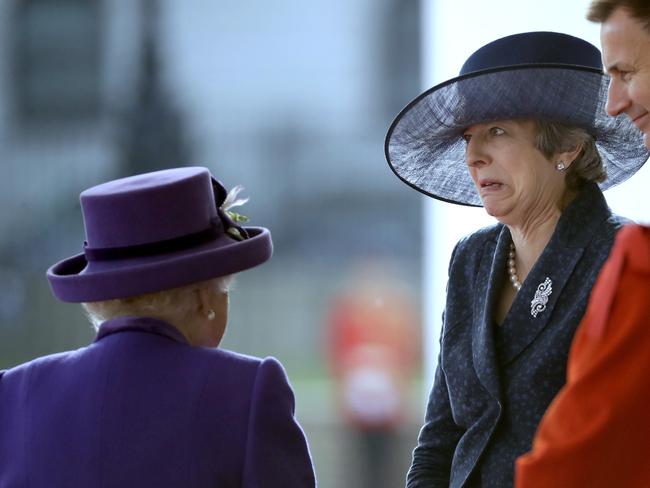 Britain's Queen Elizabeth chats with Britain's Prime Minister Theresa May as they wait to greet Dutch King Willem-Alexander and his wife Queen Maxima to inspect an honour guard during a Ceremonial Welcome on Horse Guards Parade in London, Tuesday, Oct. 23, 2018. Dutch King Willem-Alexander and Queen Maxima are on a State Visit to Britain. (AP Photo/Matt Dunham, Pool)