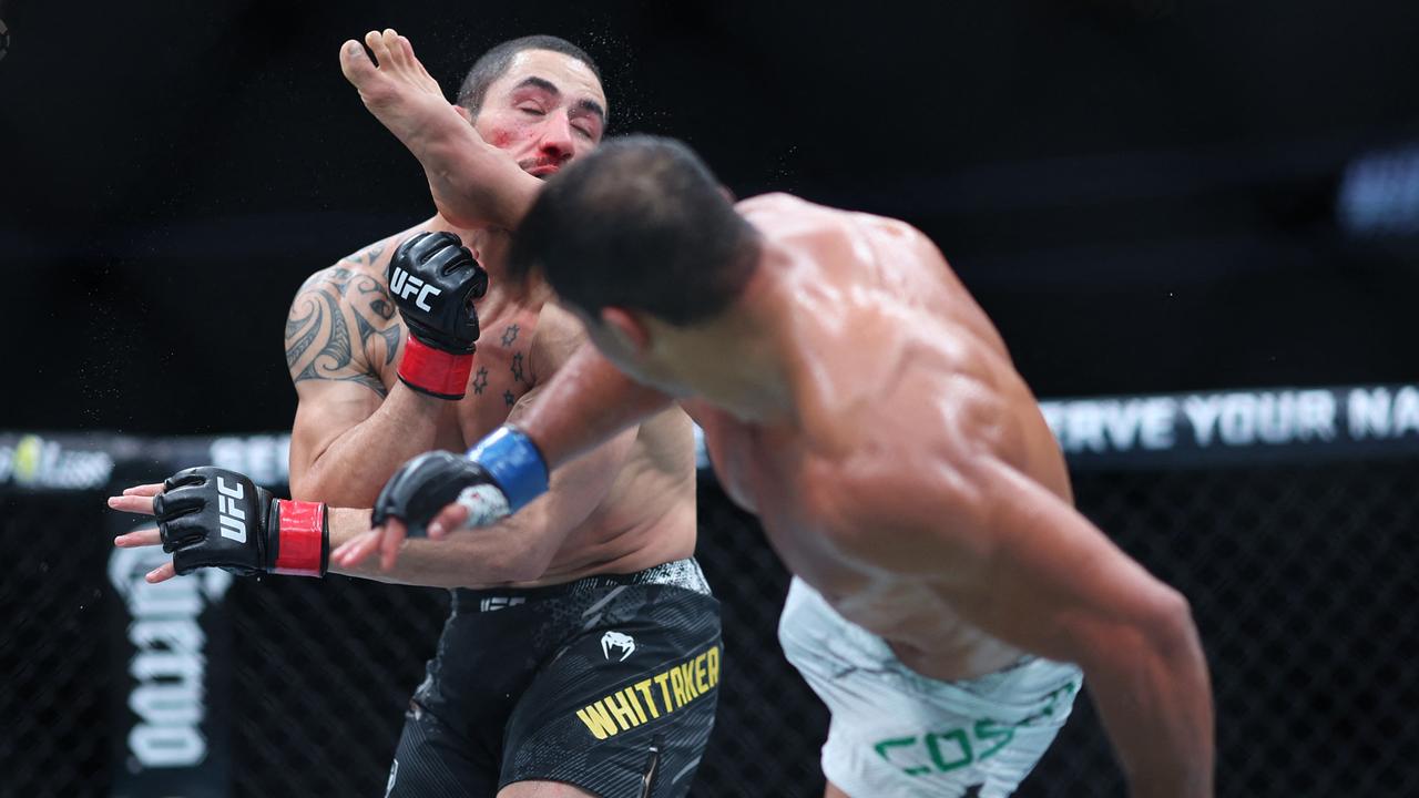 Robert Whittaker is kicked by Paulo Costa in their middleweight fight during UFC 298 at Honda Center on February 17, 2024 in Anaheim, California. Sean M. Haffey/Getty Images/AFP