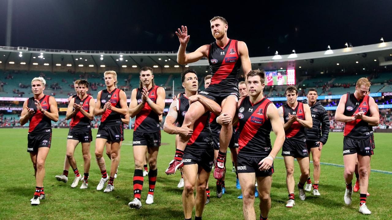 Dyson Heppell is chaired from the field by teammates after playing his 200th match.