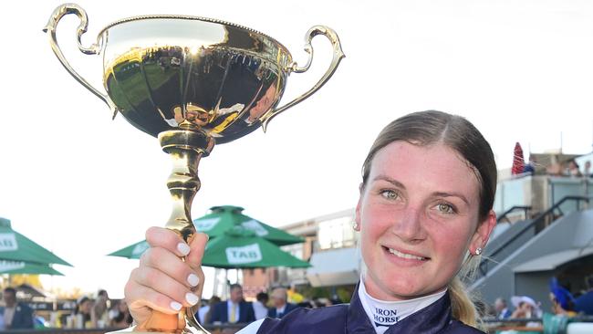 Jockey Jamie Kah hold the trophy aloft after winning the Adelaide Cup on Daqiansweet Junior Picture: Michael Marschall