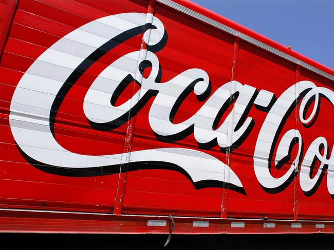 This Monday, June 25, 2012 photo shows the Coca-Cola logo on the side of a delivery truck in Springfield, Ill. Coca-Cola, the world's biggest beverage maker, is working with fitness and nutrition experts who suggest its cola as a healthy treat. (AP Photo/Seth Perlman)