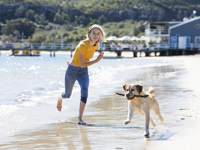 Caitlin Harbot, 11, with Myffy the Labrador at Station Beach, opposite Palm Beach, which supporters are hoping will become an off-leash dog area. Picture: Dylan Robinson