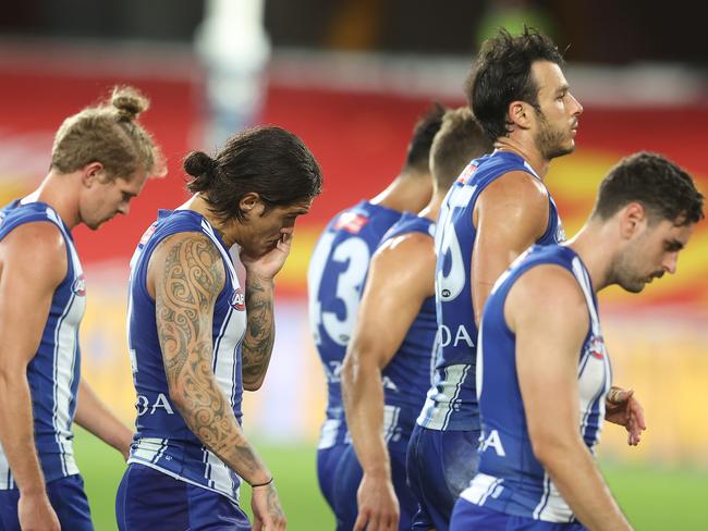 GOLD COAST, AUSTRALIA - AUGUST 30:  Kangaroos leave the field after losing the round 14 AFL match between the Gold Coast Suns and the North Melbourne Kangaroos at Metricon Stadium on August 30, 2020 in Gold Coast, Australia. (Photo by Chris Hyde/Getty Images)