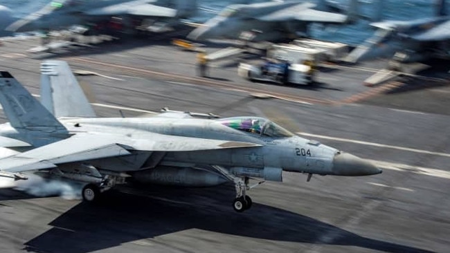 A jet fighter lands on the US Navy aircraft carrier USS Dwight D. Eisenhower in the Arabian Gulf. Picture: US Navy/Reuters/WSJ