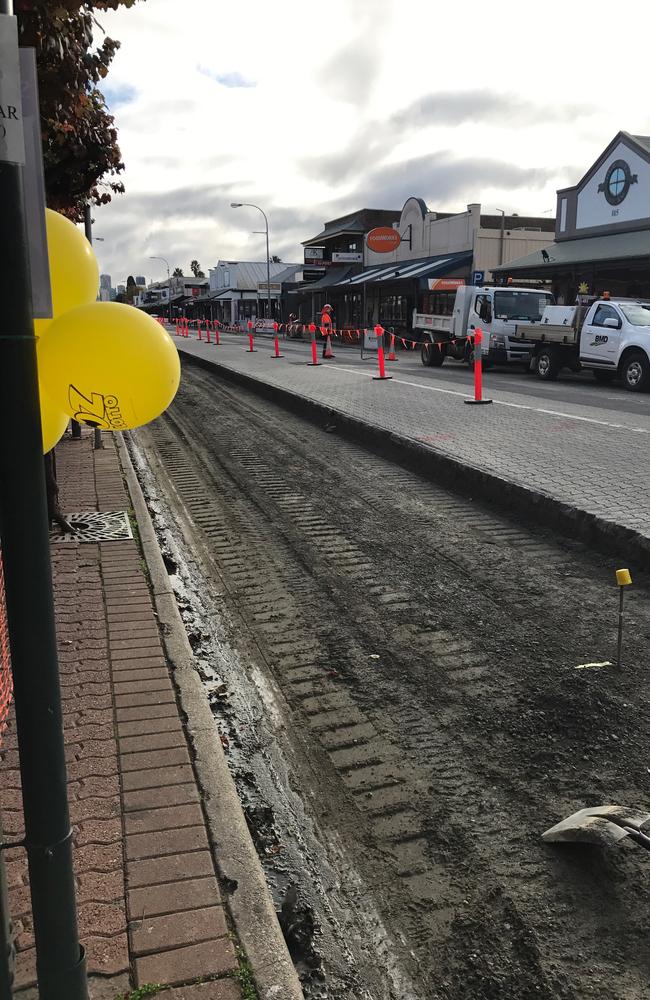 The road is riped up outside the Extra Newsagency at Hyde Park on King William Rd.