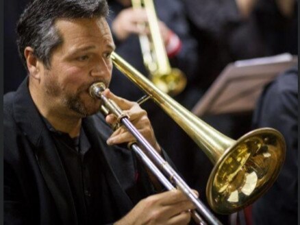 Layne Visser, a music teacher at Barrenjoey High, playing the trombone with the Big Village Band. Picture: Facebook.