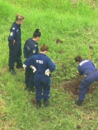 Police officers dig on a twelve tribes property near the NSW town of Picton. Picture: ABC