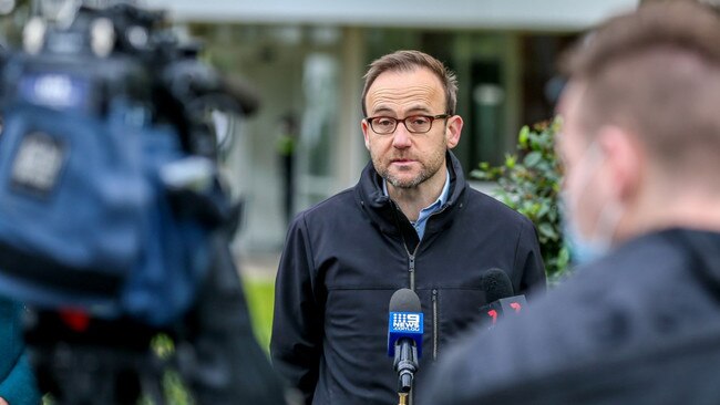 Duly noted: Adam Bandt keeps an eye peeled outside North Melbourne’s locked down towers for errant missives. Picture: Tim Carrafa