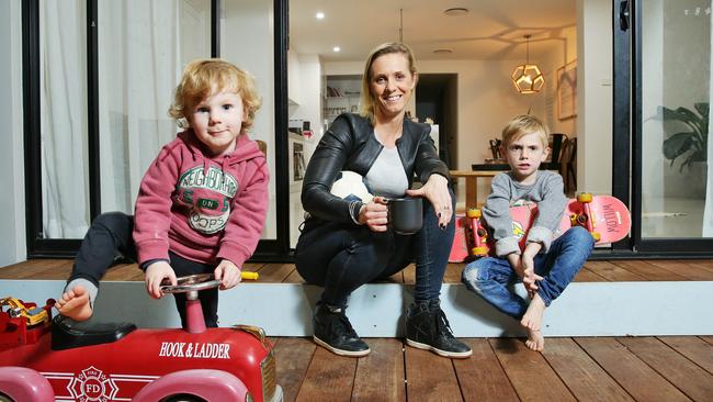 Dr Kristy Goodwin, who is launching her new book "Raising your child in a digital world" next week, with her two boys Billy, 2, and Taj, 5. Picture: Braden Fastier